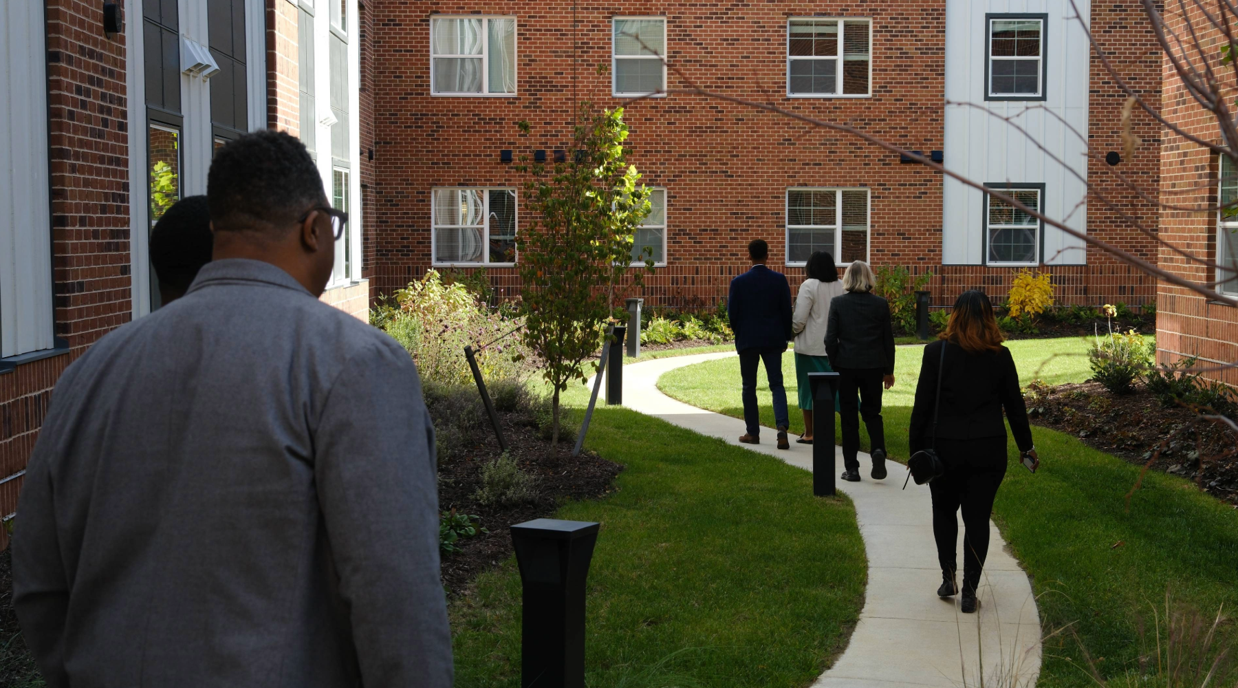 Citizens walk through an affordable housing apartment complex in Richmond, VA