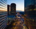 a dusk photo of the City of Richmond between two glass office buildings