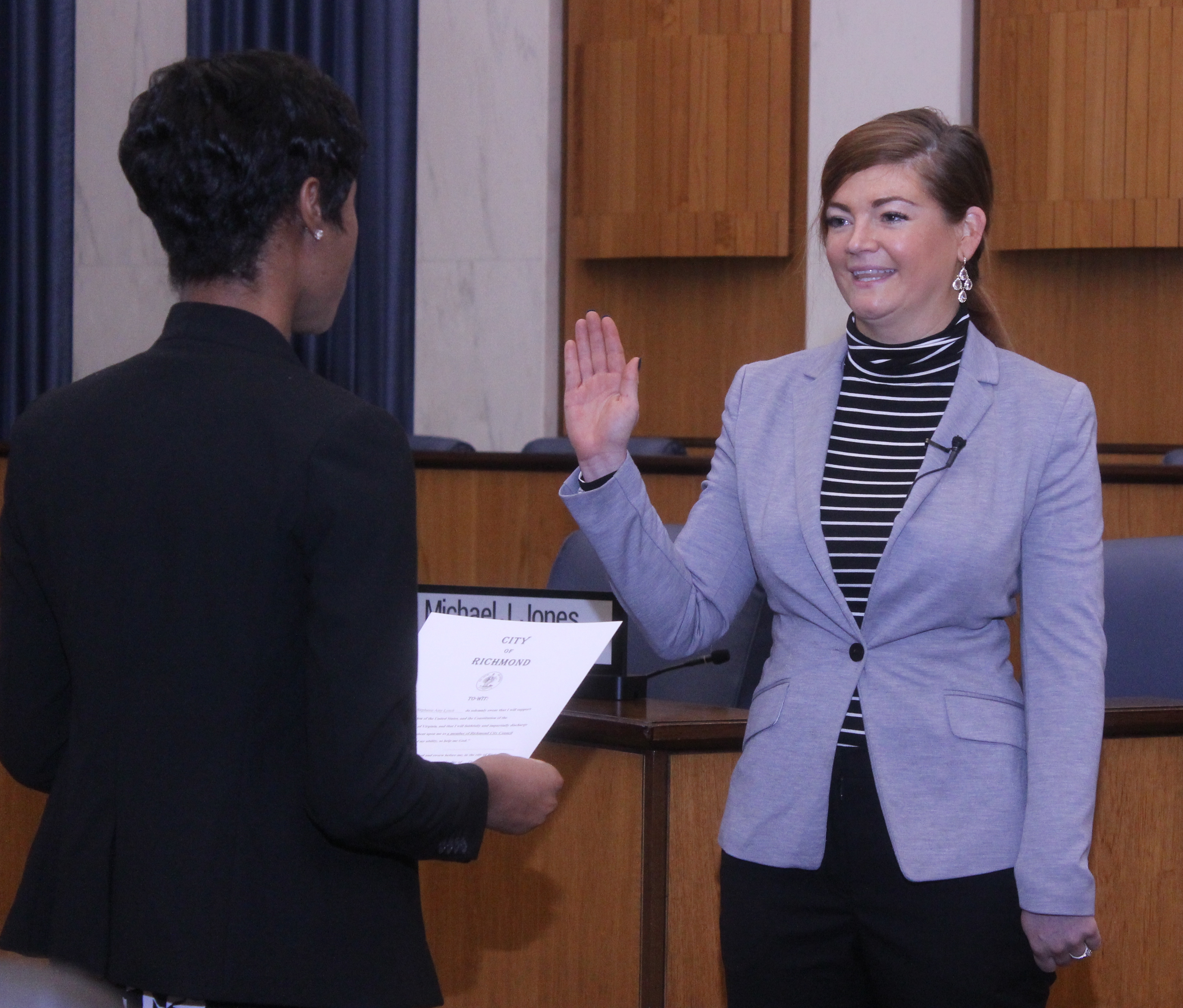 City Clerk Candice Reid swearing in Councilor Lynch