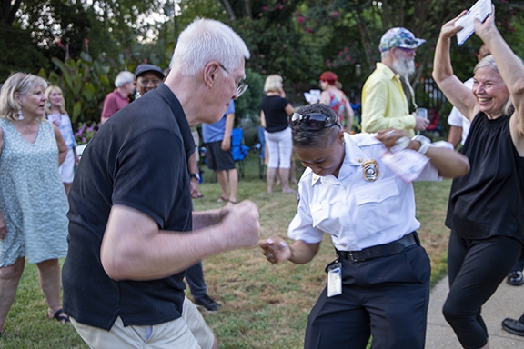 Staff dance with attendees at National Night Out 2022