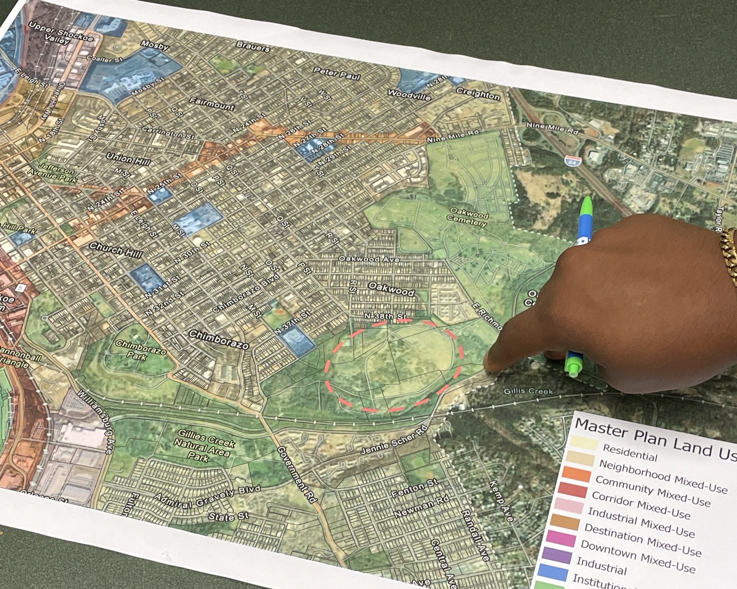 A hand points to the East Richmond Landfill on a map of Richmond.