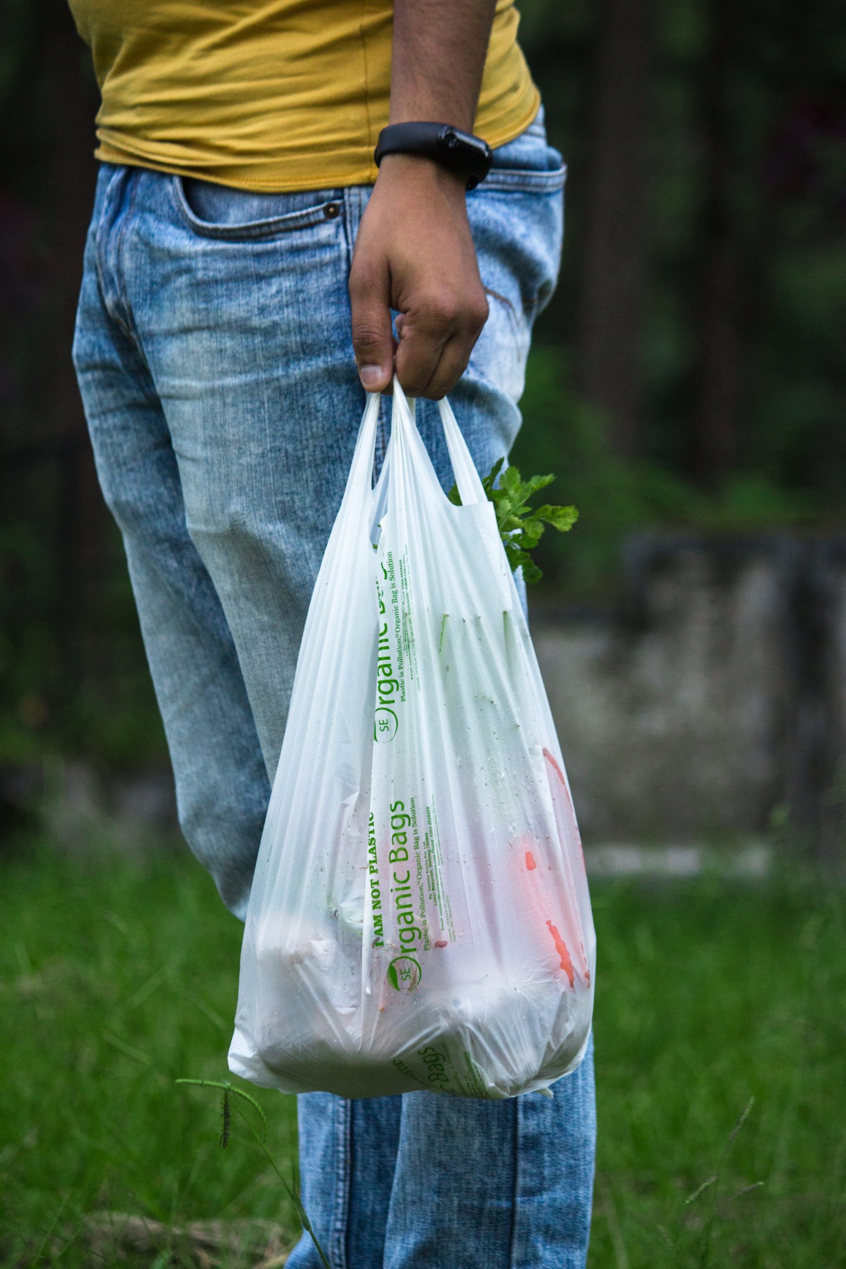 a man is holding a plastic bag