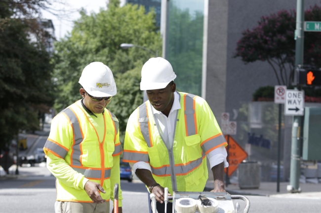 Mayor Stoney learns how to mark a crosswalk for pedestrian safety. 